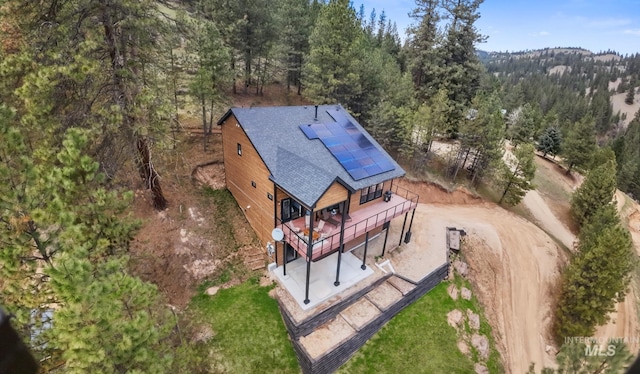 birds eye view of property with a wooded view