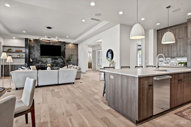 1771 S Riparian Way, Eagle, ID 83616 - kitchen with modern cabinets, a sink, a spacious island, light countertops, and light wood finished floors
