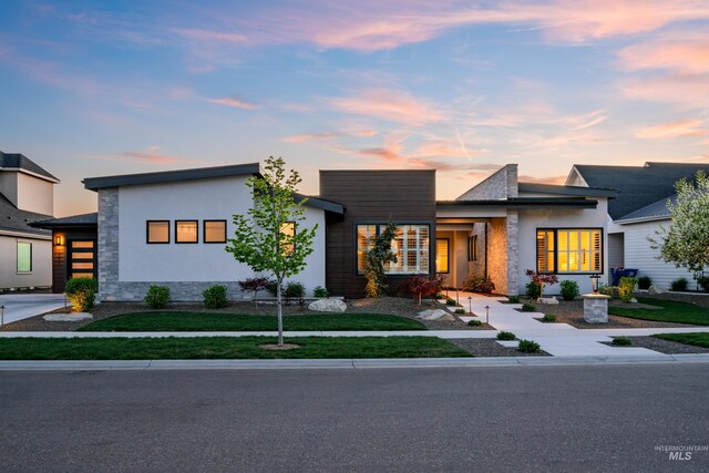 1771 S Riparian Way, Eagle, ID 83616 - contemporary home with stucco siding, a front lawn, and stone siding