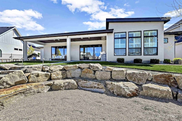 1771 S Riparian Way, Eagle, ID 83616 - rear view of house with a patio and stucco siding