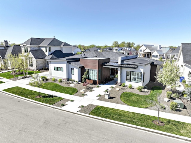 1771 S Riparian Way, Eagle, ID 83616 - view of front of house featuring a residential view, a standing seam roof, driveway, an attached garage, and stucco siding