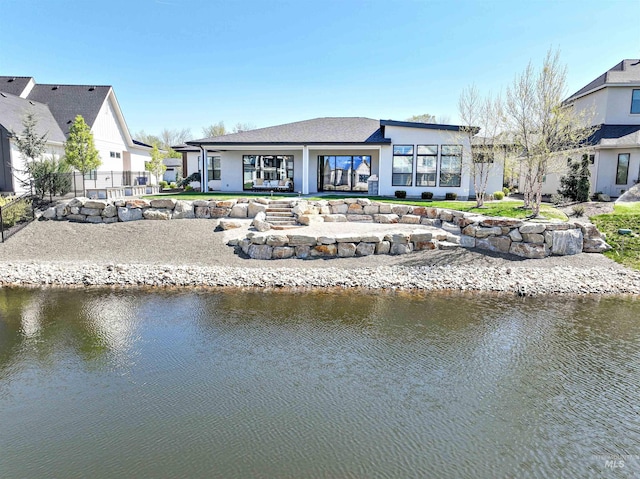 1771 S Riparian Way, Eagle, ID 83616 - back of property featuring a water view, fence, and stucco siding