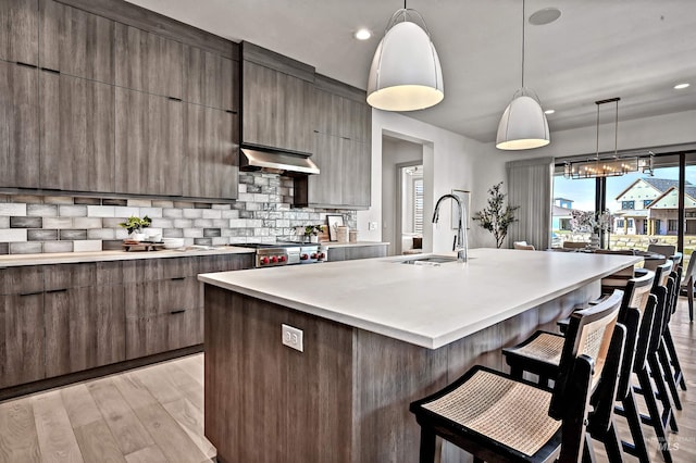 1771 S Riparian Way, Eagle, ID 83616 - kitchen with a sink, modern cabinets, extractor fan, light countertops, and recessed lighting