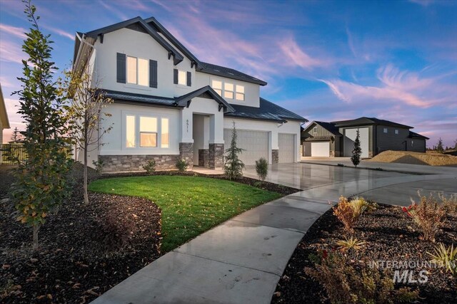 view of front of property with a front yard and a garage