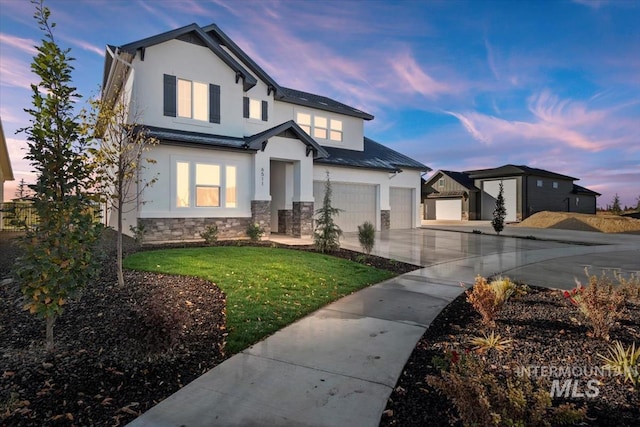 view of front facade with a garage, concrete driveway, stone siding, a front lawn, and stucco siding