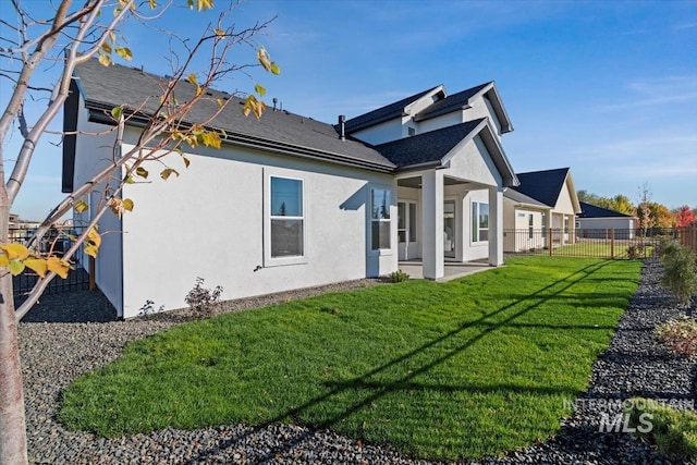 6511 W Donatella St, Eagle, ID 83616 - view of side of home featuring a yard, fence, a patio area, and stucco siding
