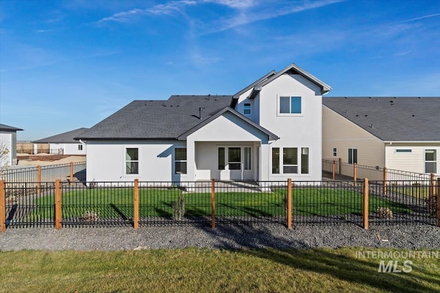 6511 W Donatella St, Eagle, ID 83616 - rear view of house featuring a yard, a shingled roof, a fenced backyard, and stucco siding