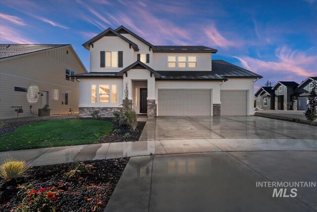 6511 W Donatella St, Eagle, ID 83616 - view of front of home featuring a yard, driveway, stone siding, and stucco siding
