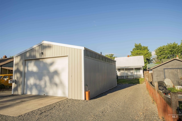 detached garage with driveway and fence