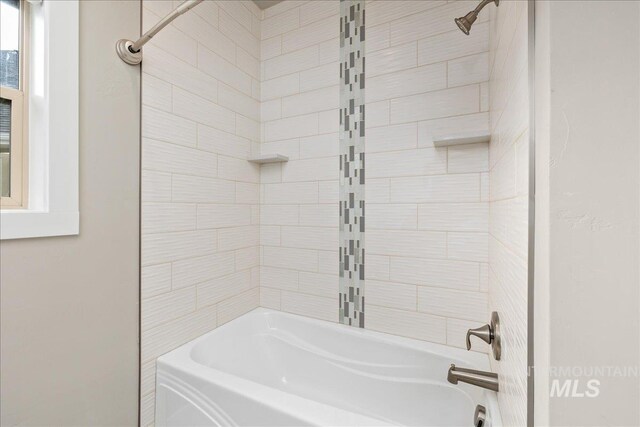 bathroom with bathing tub / shower combination