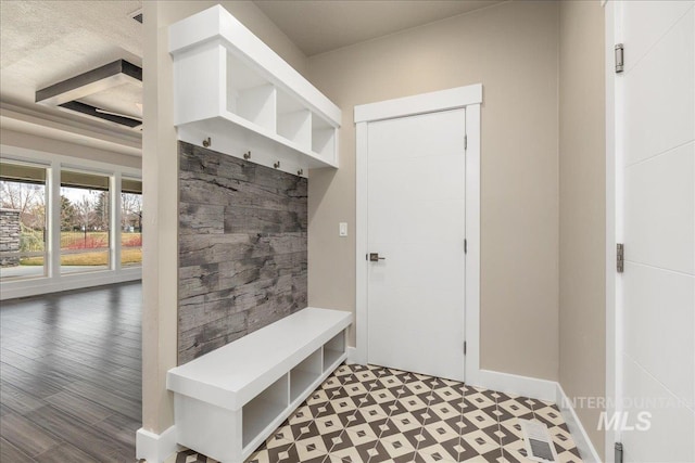 mudroom with tile patterned floors and baseboards