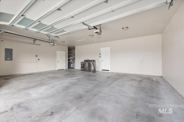 garage with electric panel and a garage door opener