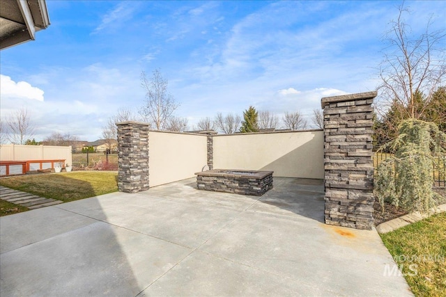 view of patio / terrace with an outdoor fire pit and fence