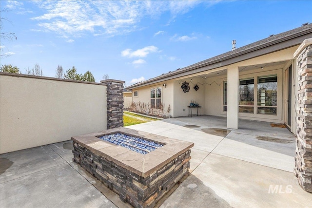 view of patio / terrace with an outdoor fire pit