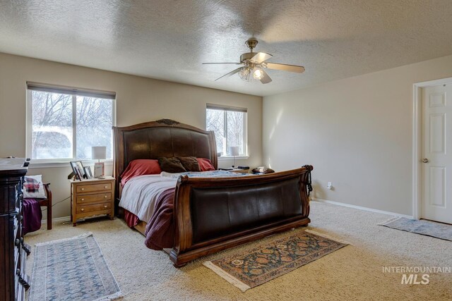 1587 N Firebrick Dr, Kuna, ID 83634 - bedroom featuring a textured ceiling, baseboards, a ceiling fan, and light colored carpet