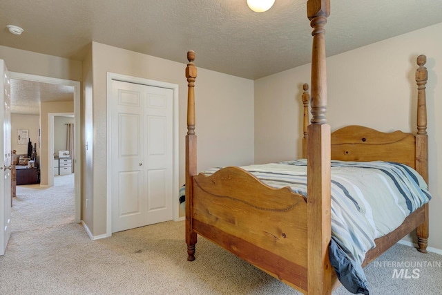 1587 N Firebrick Dr, Kuna, ID 83634 - bedroom with light carpet, a closet, a textured ceiling, and baseboards