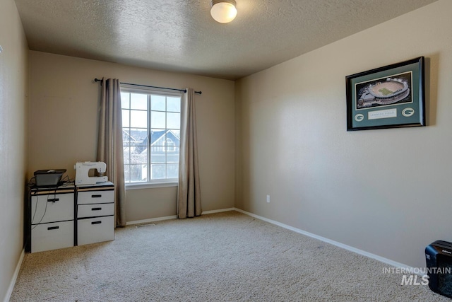 1587 N Firebrick Dr, Kuna, ID 83634 - interior space featuring carpet floors, visible vents, a textured ceiling, and baseboards
