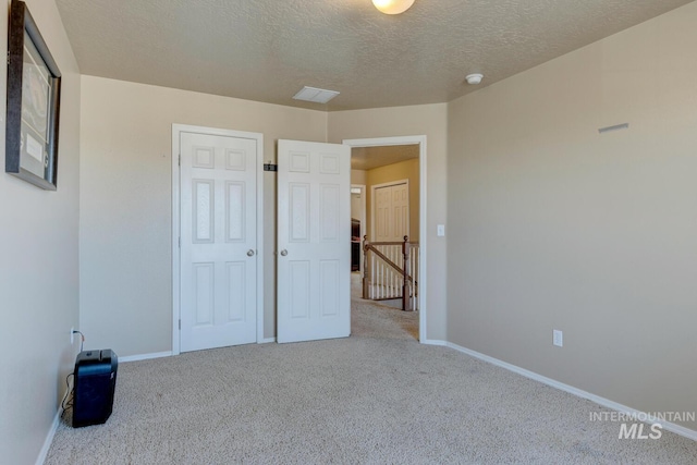 1587 N Firebrick Dr, Kuna, ID 83634 - unfurnished bedroom with carpet, baseboards, and a textured ceiling
