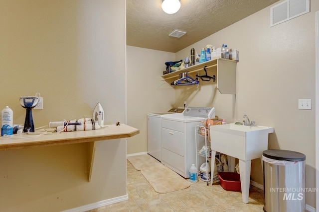 1587 N Firebrick Dr, Kuna, ID 83634 - clothes washing area with a textured ceiling, laundry area, visible vents, baseboards, and washer and clothes dryer