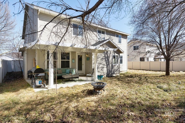 1587 N Firebrick Dr, Kuna, ID 83634 - back of property with an outdoor living space with a fire pit, a patio area, and a fenced backyard