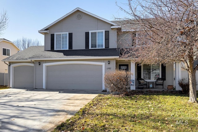 1587 N Firebrick Dr, Kuna, ID 83634 - traditional home featuring a porch, a garage, driveway, roof with shingles, and a front yard
