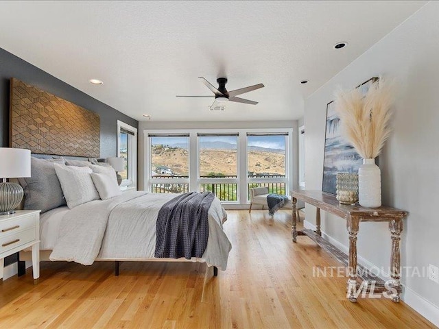 bedroom featuring light wood-type flooring, ceiling fan, baseboards, access to exterior, and recessed lighting