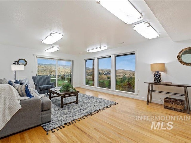 living room with a wealth of natural light, hardwood / wood-style floors, and a textured ceiling