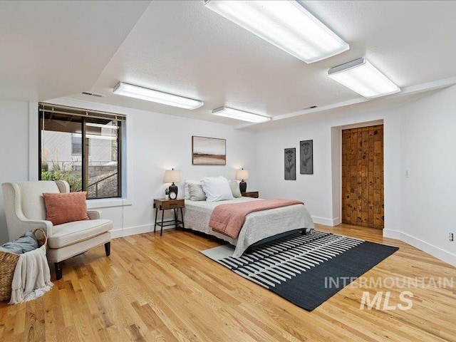 bedroom with hardwood / wood-style flooring