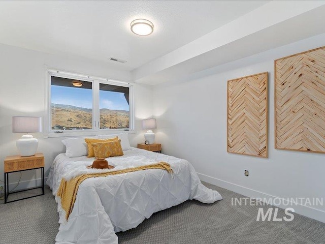 carpeted bedroom featuring visible vents and baseboards