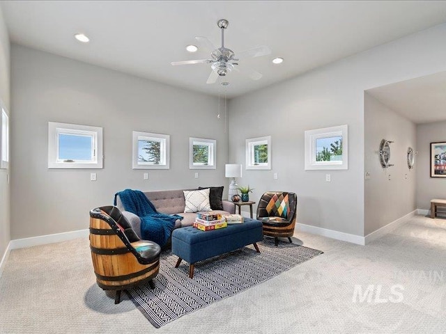 living area featuring light carpet, baseboards, recessed lighting, and ceiling fan
