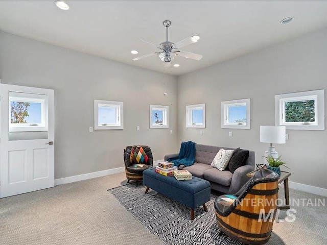 living room with ceiling fan, light colored carpet, and plenty of natural light