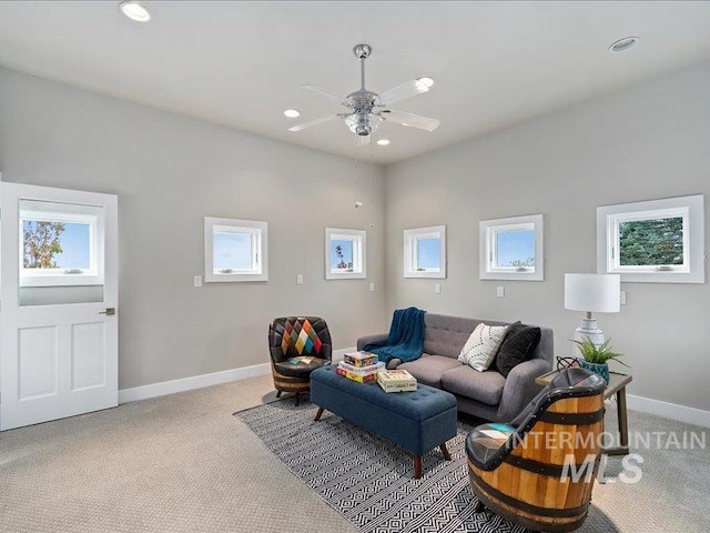 living area with recessed lighting, a wealth of natural light, and light carpet