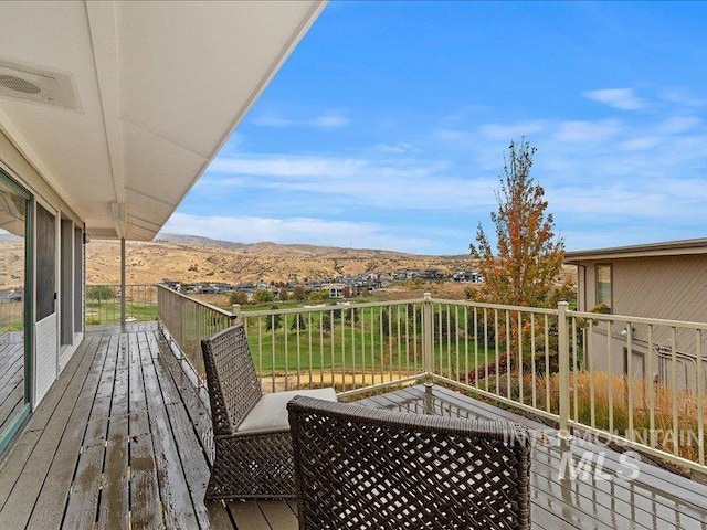 wooden deck with a mountain view