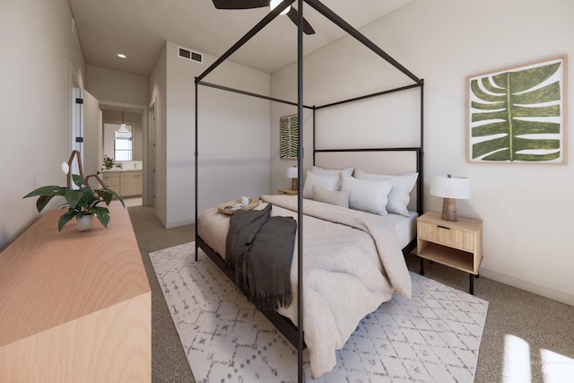 bedroom featuring ensuite bathroom, ceiling fan, and light carpet