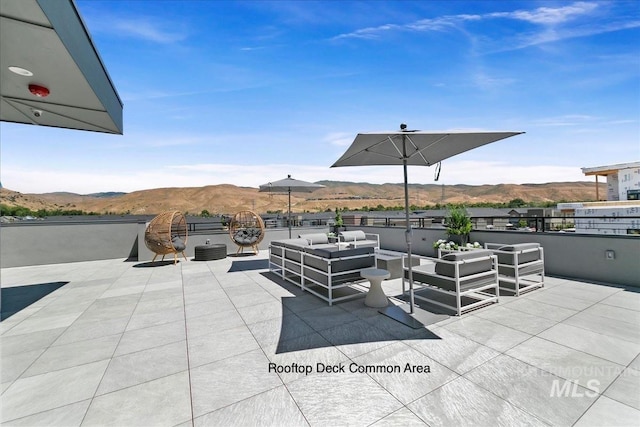 view of patio / terrace featuring an outdoor hangout area and a mountain view