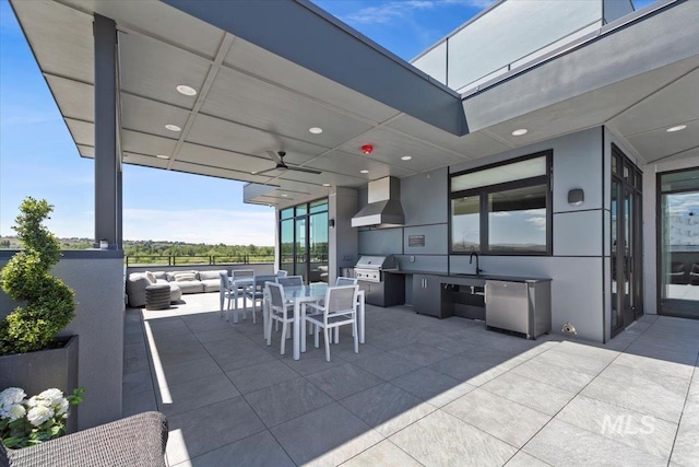 view of patio featuring an outdoor hangout area, an outdoor kitchen, area for grilling, ceiling fan, and sink