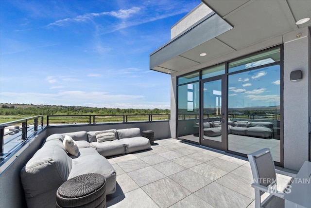 view of patio featuring an outdoor hangout area and a balcony