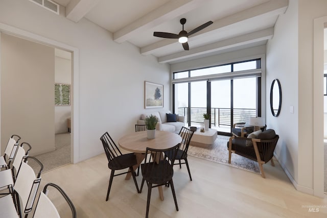 dining area featuring ceiling fan, light wood-type flooring, and beamed ceiling