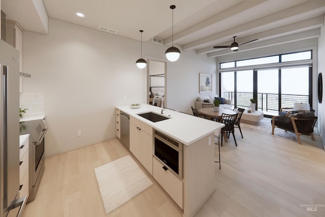 kitchen featuring sink, dishwasher, ceiling fan, kitchen peninsula, and pendant lighting