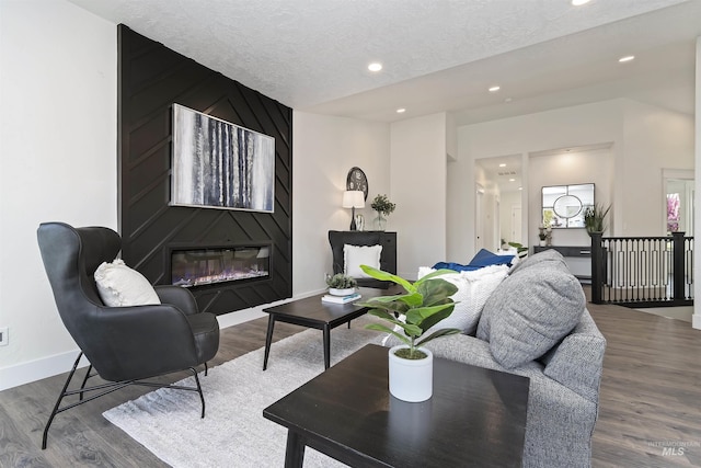1910 W Campo Ln, Eagle, ID 83616 - living area with a fireplace, baseboards, recessed lighting, wood finished floors, and a textured ceiling
