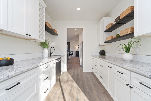 1910 W Campo Ln, Eagle, ID 83616 - kitchen with open shelves, light wood finished floors, white cabinetry, a sink, and recessed lighting