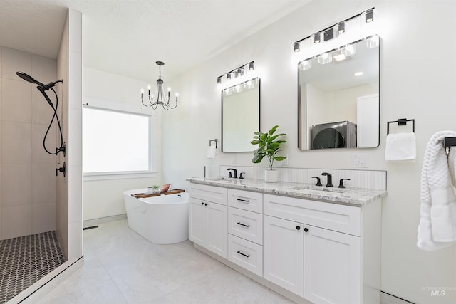 1910 W Campo Ln, Eagle, ID 83616 - bathroom with a chandelier, tiled shower, a soaking tub, double vanity, and tile patterned flooring