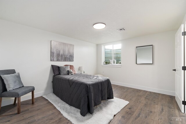 1910 W Campo Ln, Eagle, ID 83616 - bedroom with baseboards and dark wood-type flooring