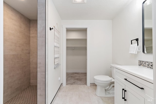 1910 W Campo Ln, Eagle, ID 83616 - full bathroom with toilet, a tile shower, a spacious closet, and vanity