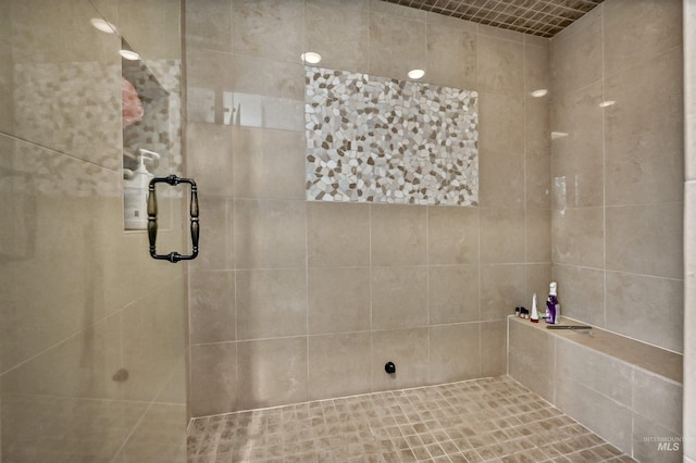 full bath with a tile shower