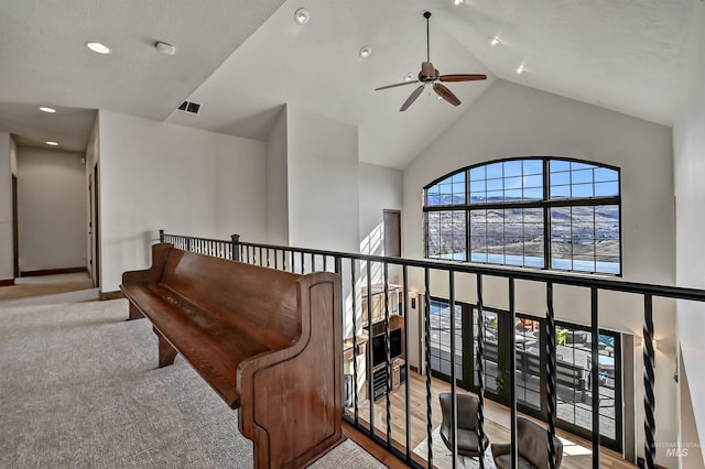 corridor featuring visible vents, baseboards, carpet floors, recessed lighting, and high vaulted ceiling