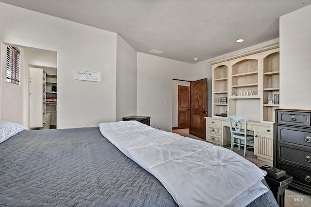 bedroom featuring recessed lighting and built in study area