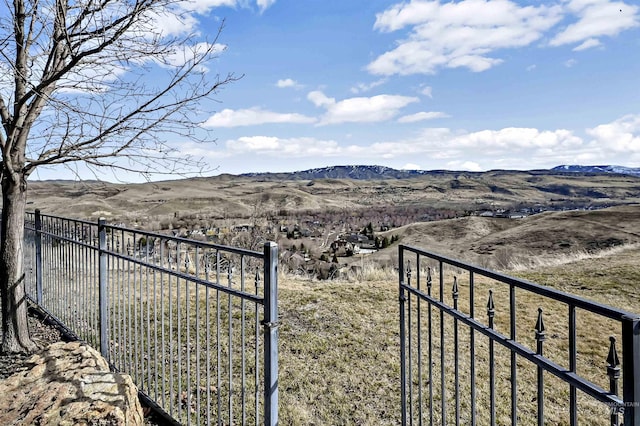 view of yard featuring a mountain view and fence