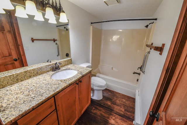 1607 Davis Ave Unit C2, Mccall, ID 83638 - bathroom featuring wood finished floors, toilet, vanity, and bathing tub / shower combination