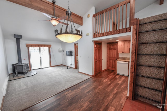 1607 Davis Ave Unit C2, Mccall, ID 83638 - unfurnished living room with a ceiling fan, baseboards, a wood stove, high vaulted ceiling, and beam ceiling